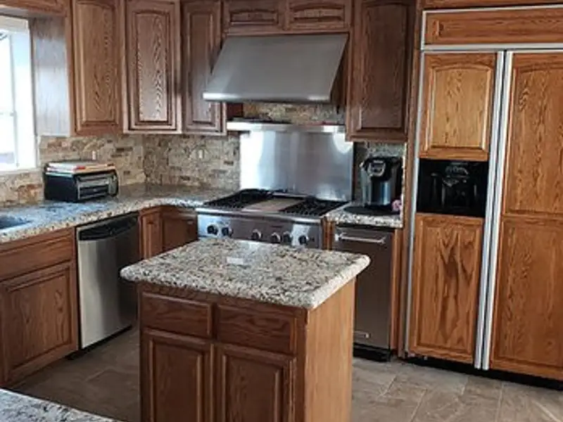Refinished kitchen cabinetry with granite counters